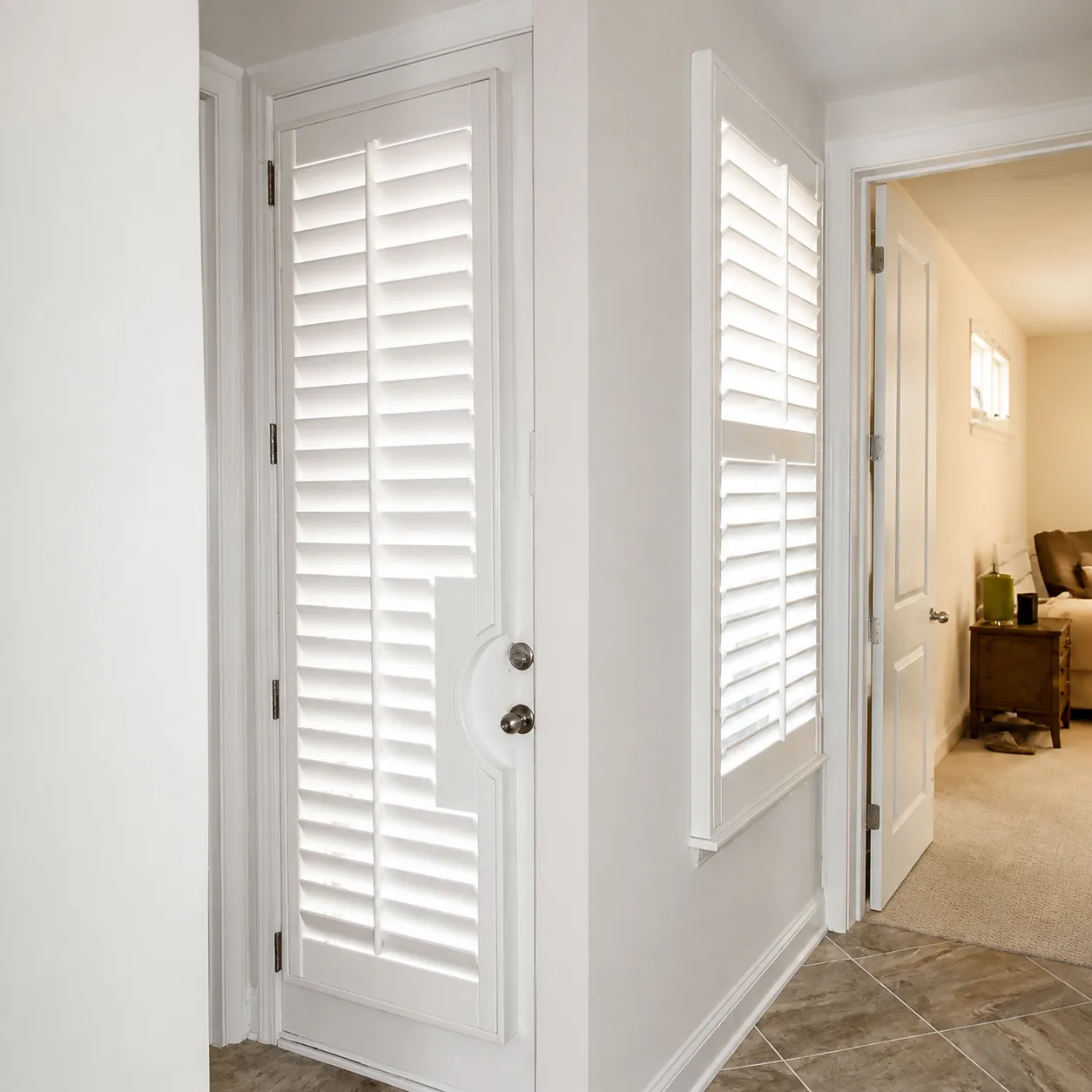 Custom door and sidelight shutters in Nocatee Custom white door and sidelight shutters fitted for privacy in a Nocatee home